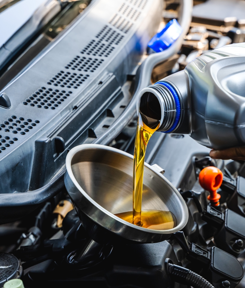 Auto,Mechanic,Pouring,Engine,Oil,During,Car,Maintenance,In,Auto